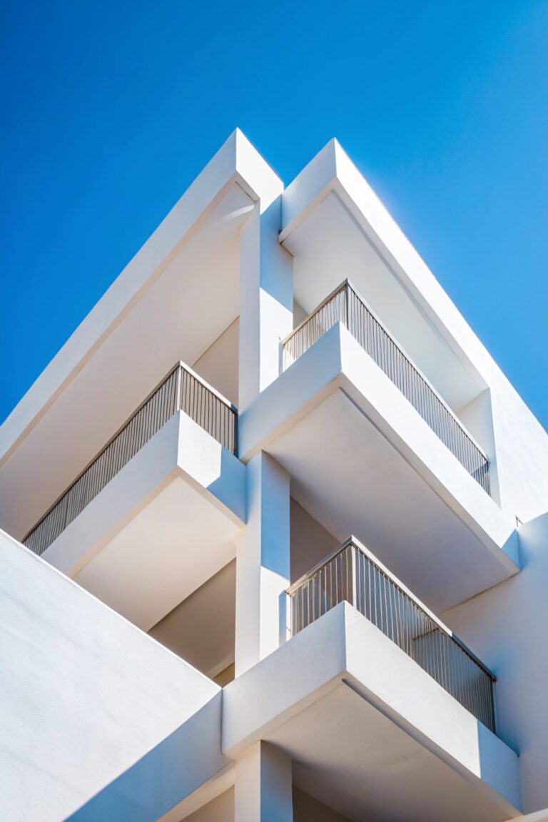 Abstract architecture background texture. Close up of geometric structure made of balconies fragments, white buildind walls against clear blue sky. Concrete, perspective, composition